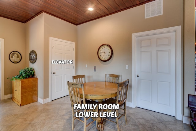 dining space with ornamental molding and wooden ceiling