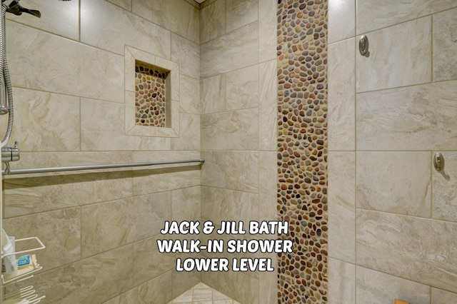 bathroom with a tile shower