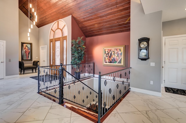 stairway with wooden ceiling, high vaulted ceiling, and french doors