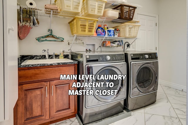 washroom featuring washing machine and clothes dryer and sink