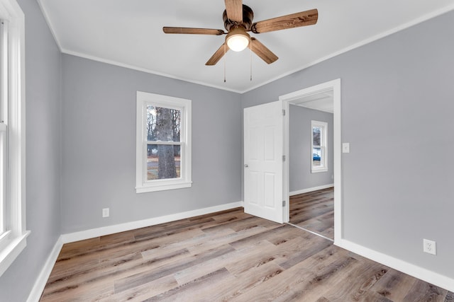 spare room with crown molding, ceiling fan, and light hardwood / wood-style flooring