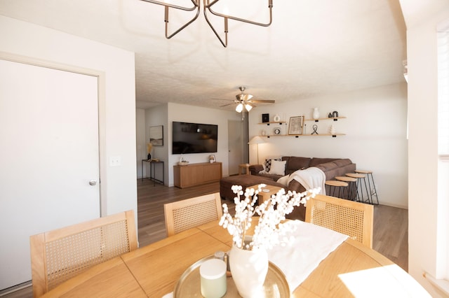 dining space with hardwood / wood-style flooring and ceiling fan