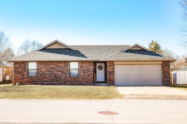 ranch-style home with a garage and a front lawn