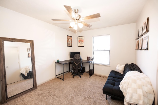 carpeted office space with ceiling fan