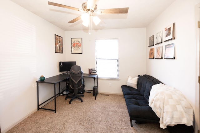 carpeted office space featuring ceiling fan