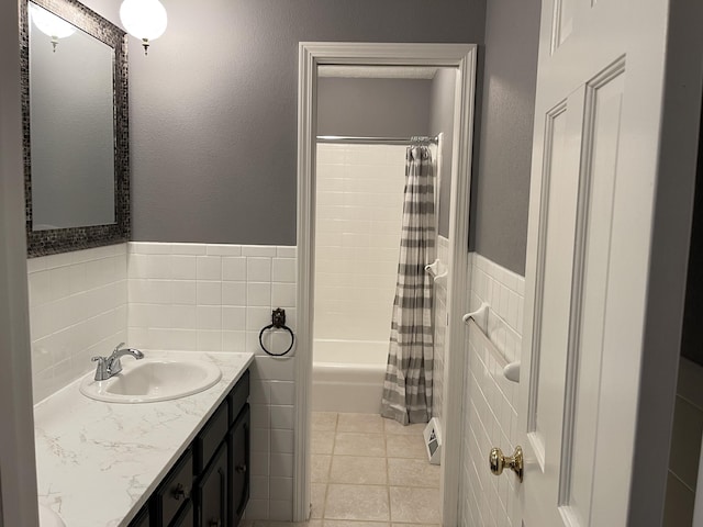 full bath featuring shower / tub combo with curtain, vanity, tile walls, and tile patterned floors