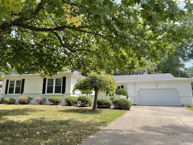 ranch-style home featuring an attached garage, driveway, brick siding, and a front yard