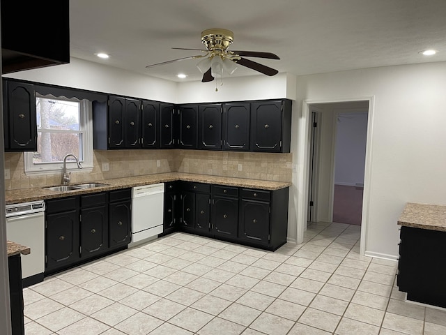 kitchen featuring sink, tasteful backsplash, light tile patterned floors, white dishwasher, and ceiling fan