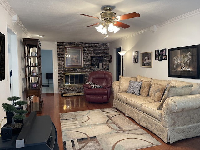 living area featuring dark wood-style floors, ornamental molding, a fireplace, and a ceiling fan