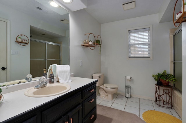 bathroom with tile patterned flooring, vanity, a shower with door, and toilet