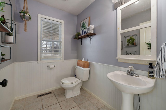 bathroom with tile patterned flooring and toilet