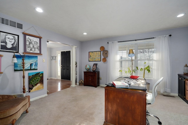 carpeted office space with ornate columns