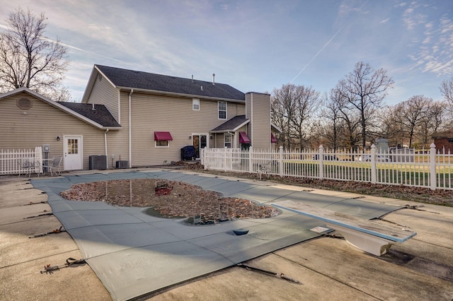 back of property featuring central AC unit and a patio area