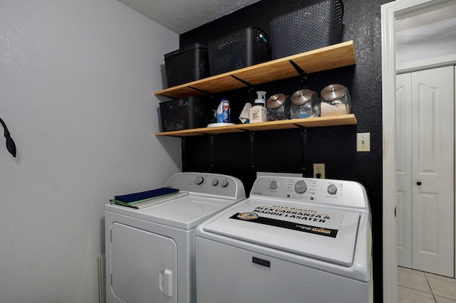 laundry area featuring independent washer and dryer and light tile patterned flooring