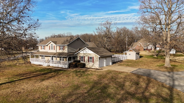 view of front of home featuring a garage, a front yard, covered porch, and a storage unit