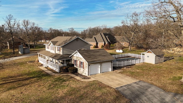 view of property exterior with a storage shed, a yard, a garage, and covered porch