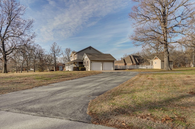 view of front of home with a garage and a front yard