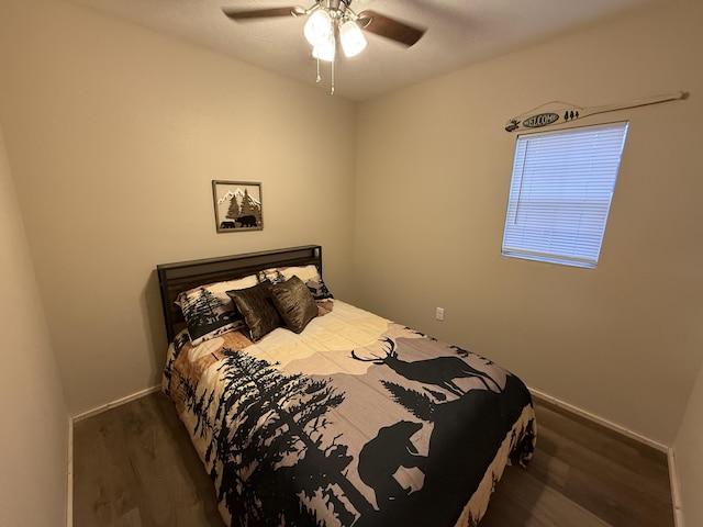 bedroom featuring dark hardwood / wood-style flooring and ceiling fan