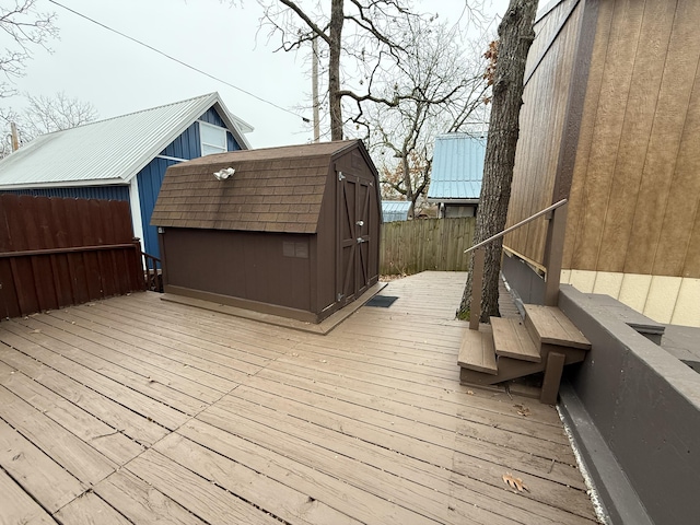 wooden terrace with a shed