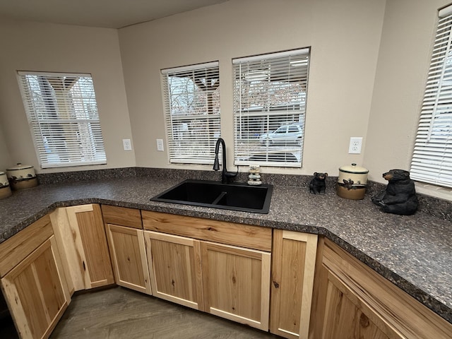 kitchen with dark wood-type flooring, light brown cabinetry, and sink