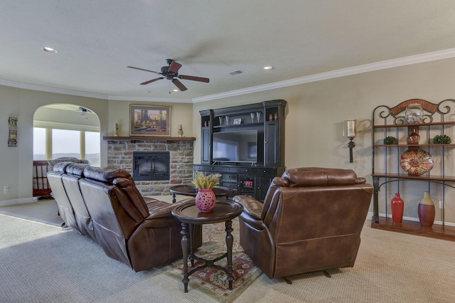 carpeted living room featuring ceiling fan, ornamental molding, and a fireplace