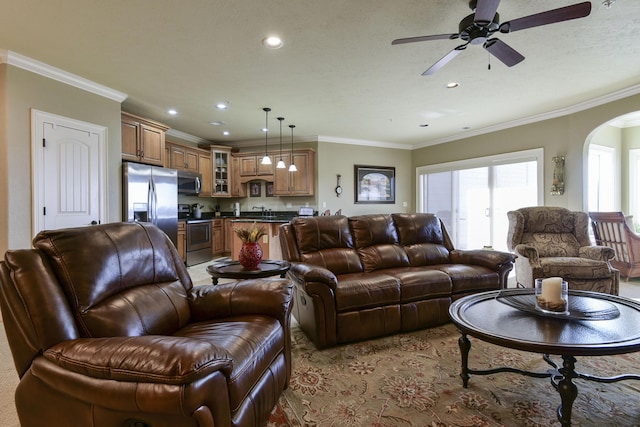 living room featuring ornamental molding and ceiling fan