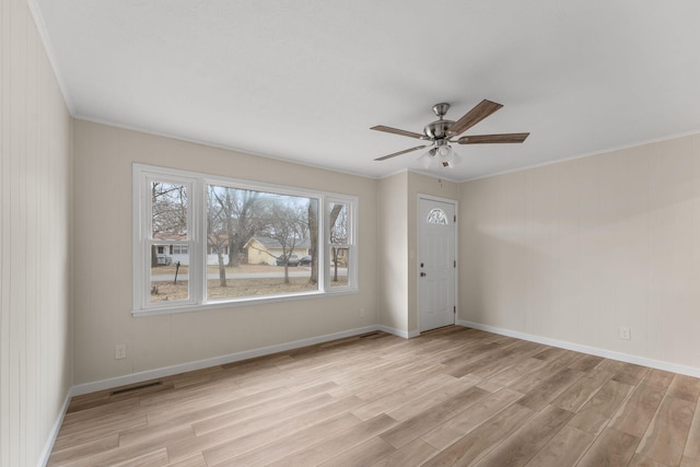 interior space featuring crown molding, ceiling fan, and light wood-type flooring