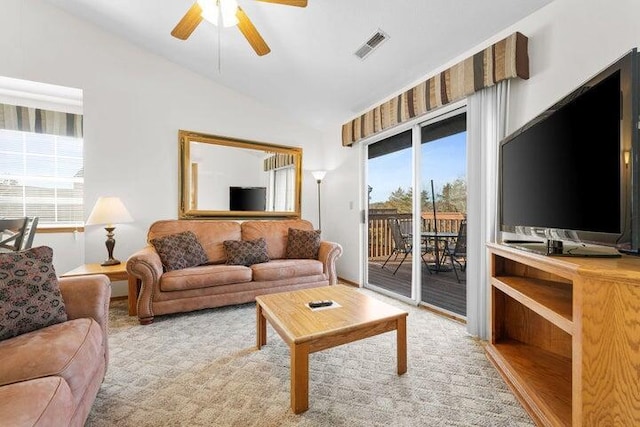 living room with vaulted ceiling, light colored carpet, and ceiling fan