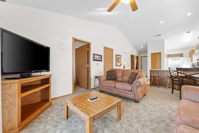 living room featuring vaulted ceiling, light carpet, and ceiling fan