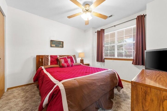 bedroom with ceiling fan and light carpet