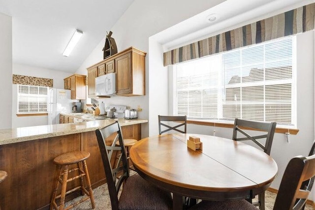 dining room featuring lofted ceiling