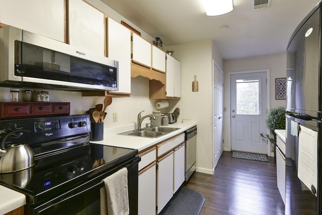 kitchen featuring sink, dark wood-type flooring, black appliances, and white cabinets