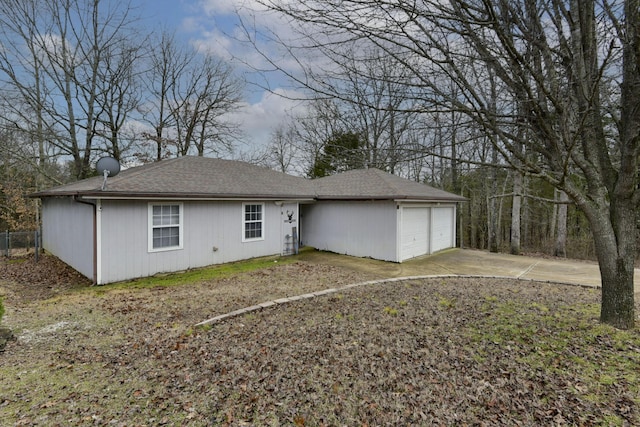 rear view of house featuring a garage