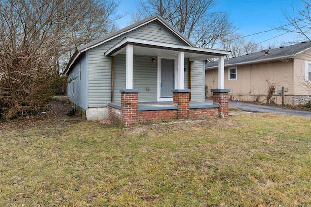 bungalow-style house with a front lawn and a porch