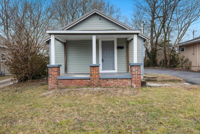 bungalow featuring a front yard and a porch