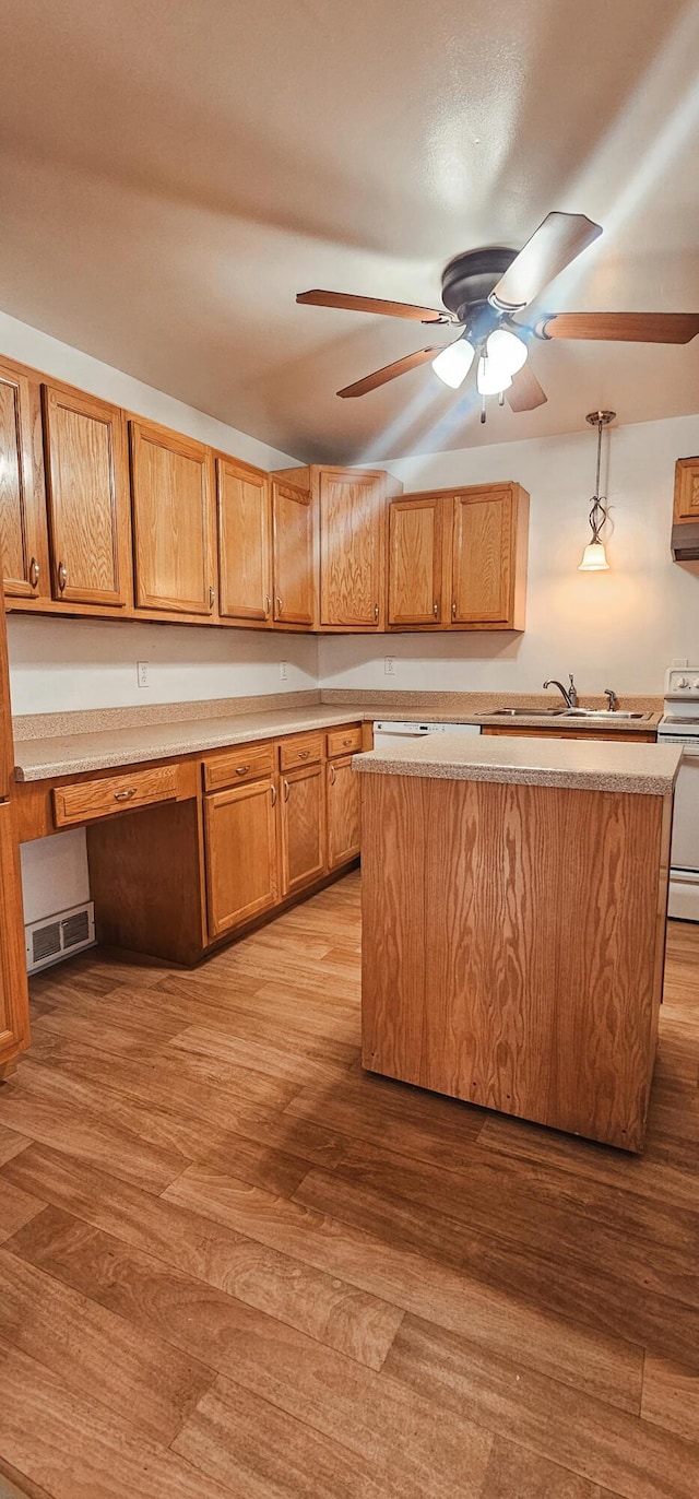 kitchen with pendant lighting, built in desk, electric range, and light hardwood / wood-style flooring