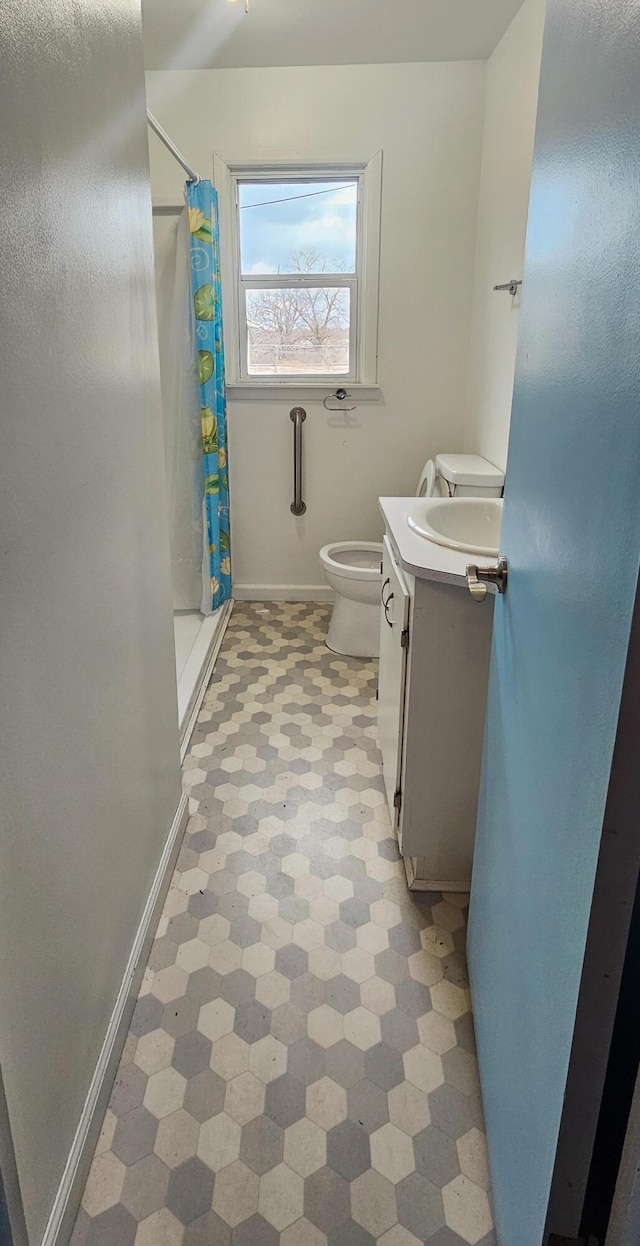 bathroom featuring vanity, toilet, and a shower with shower curtain