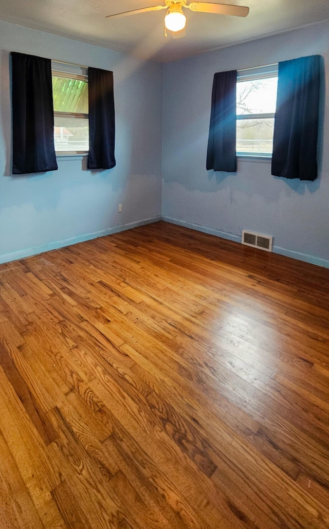 empty room with light hardwood / wood-style floors and ceiling fan