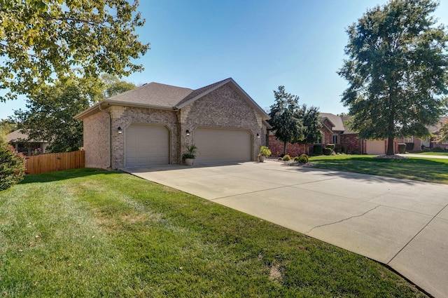 view of front of house featuring an attached garage, brick siding, fence, concrete driveway, and a front yard