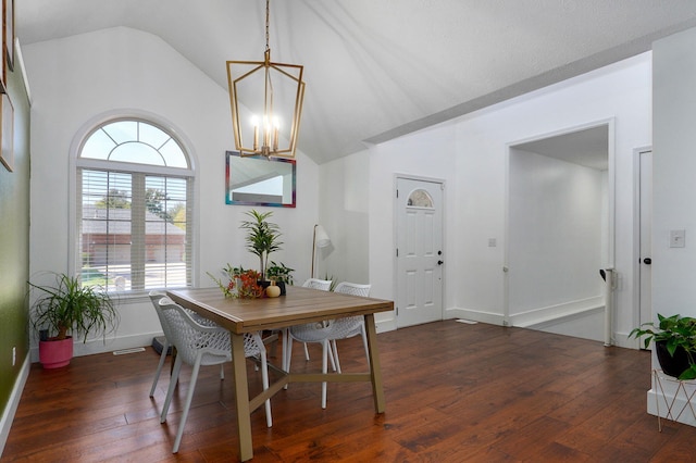 dining space featuring lofted ceiling, dark wood-type flooring, and a chandelier