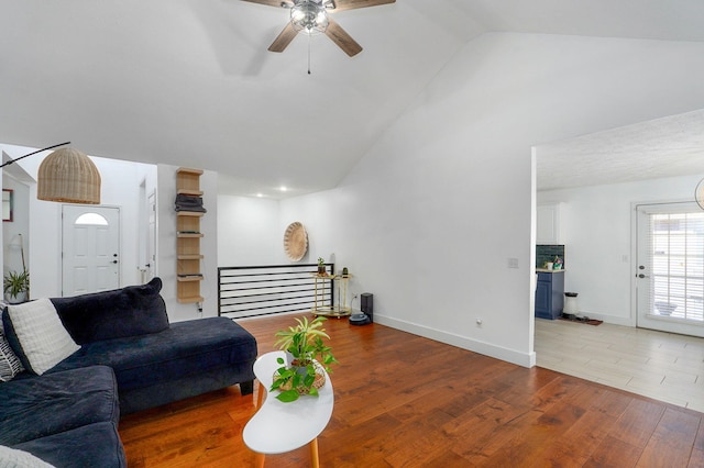 living room featuring hardwood / wood-style flooring, high vaulted ceiling, and ceiling fan