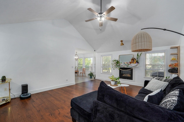 living room with ceiling fan, dark hardwood / wood-style flooring, and high vaulted ceiling