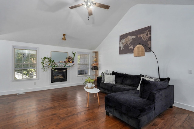 living room with dark hardwood / wood-style flooring, vaulted ceiling, and ceiling fan