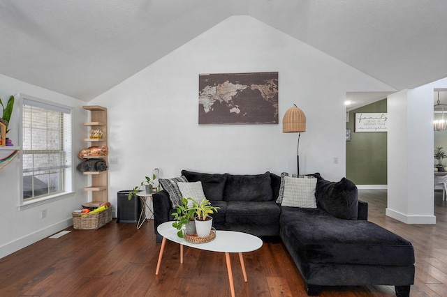 living room featuring lofted ceiling and dark hardwood / wood-style flooring