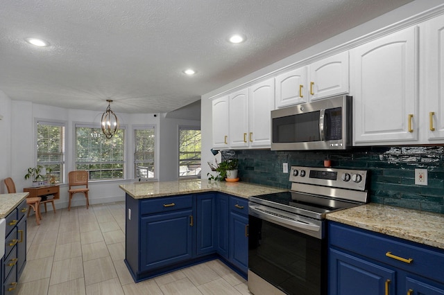 kitchen featuring appliances with stainless steel finishes, decorative backsplash, white cabinets, blue cabinets, and decorative light fixtures