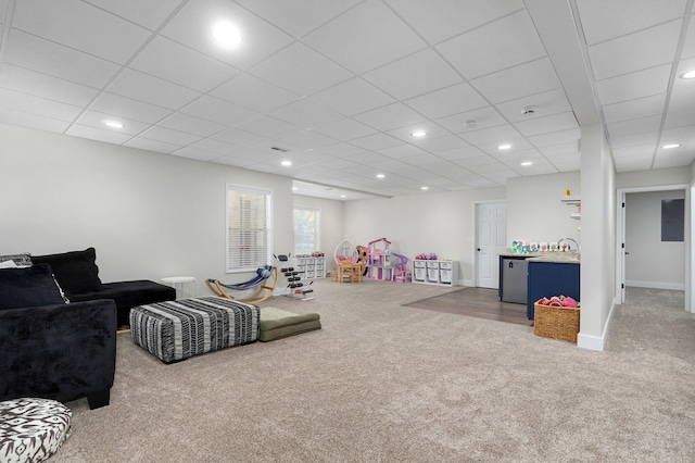 rec room featuring carpet floors, sink, and a drop ceiling