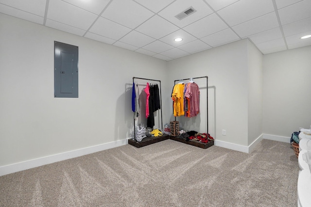 interior space featuring a drop ceiling, electric panel, and carpet flooring