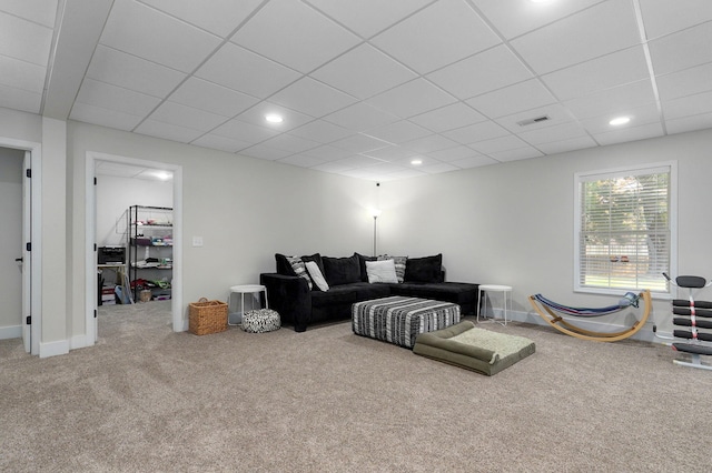 living room featuring a paneled ceiling and carpet flooring