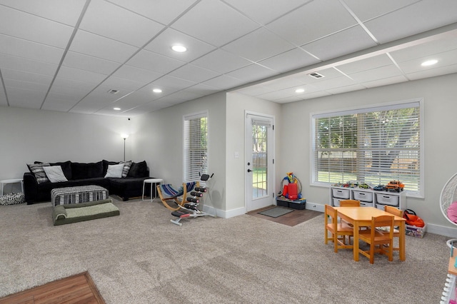 rec room featuring carpet floors and a drop ceiling