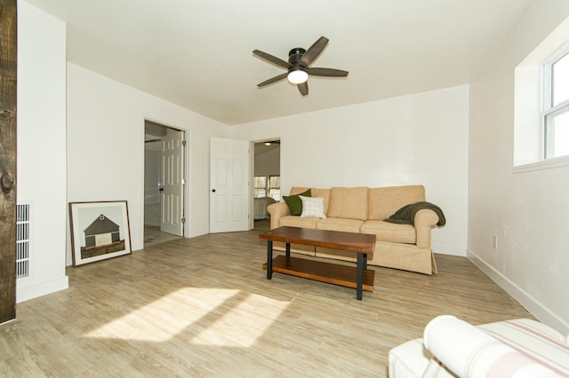 living room featuring ceiling fan and light hardwood / wood-style flooring